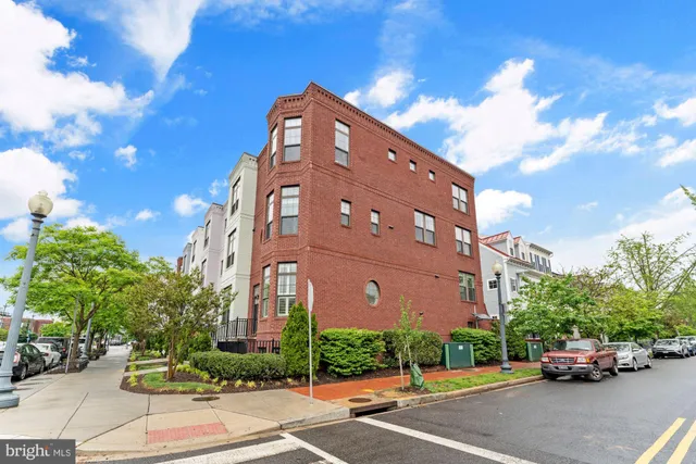 a view of walk in closet with clothes