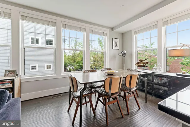 a living room with furniture a rug and a large window