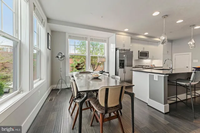 a view of a dining room with furniture and windows