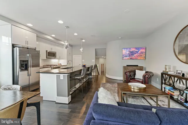 a kitchen with a table chairs refrigerator and microwave