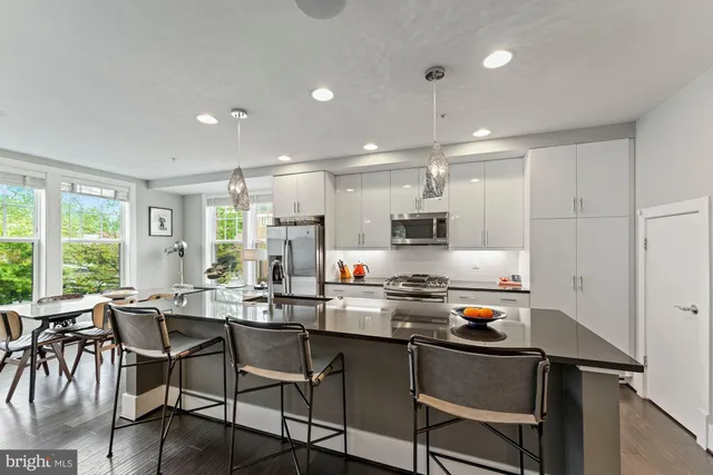 a kitchen with a table chairs stove and cabinets