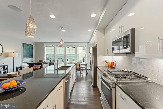 a kitchen with sink cabinets and dining table