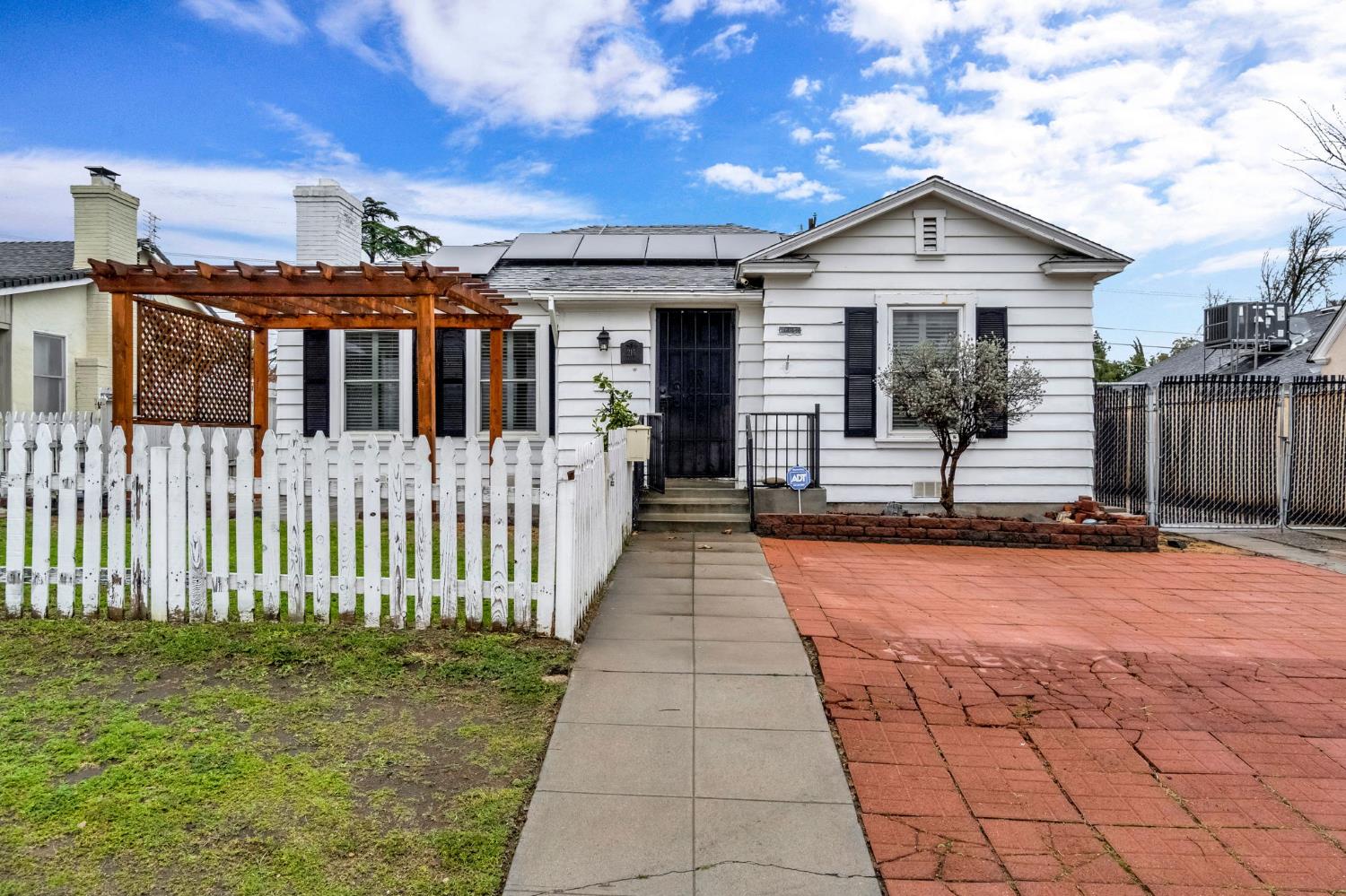 215 East Clinton Avenue Fresno, CA 93704 - Photo 1 of 29 a front view of a house with a yard