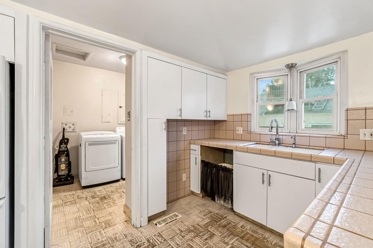 215 East Clinton Avenue Fresno, CA 93704 - Photo 11 of 29 a kitchen with a sink stove and cabinets