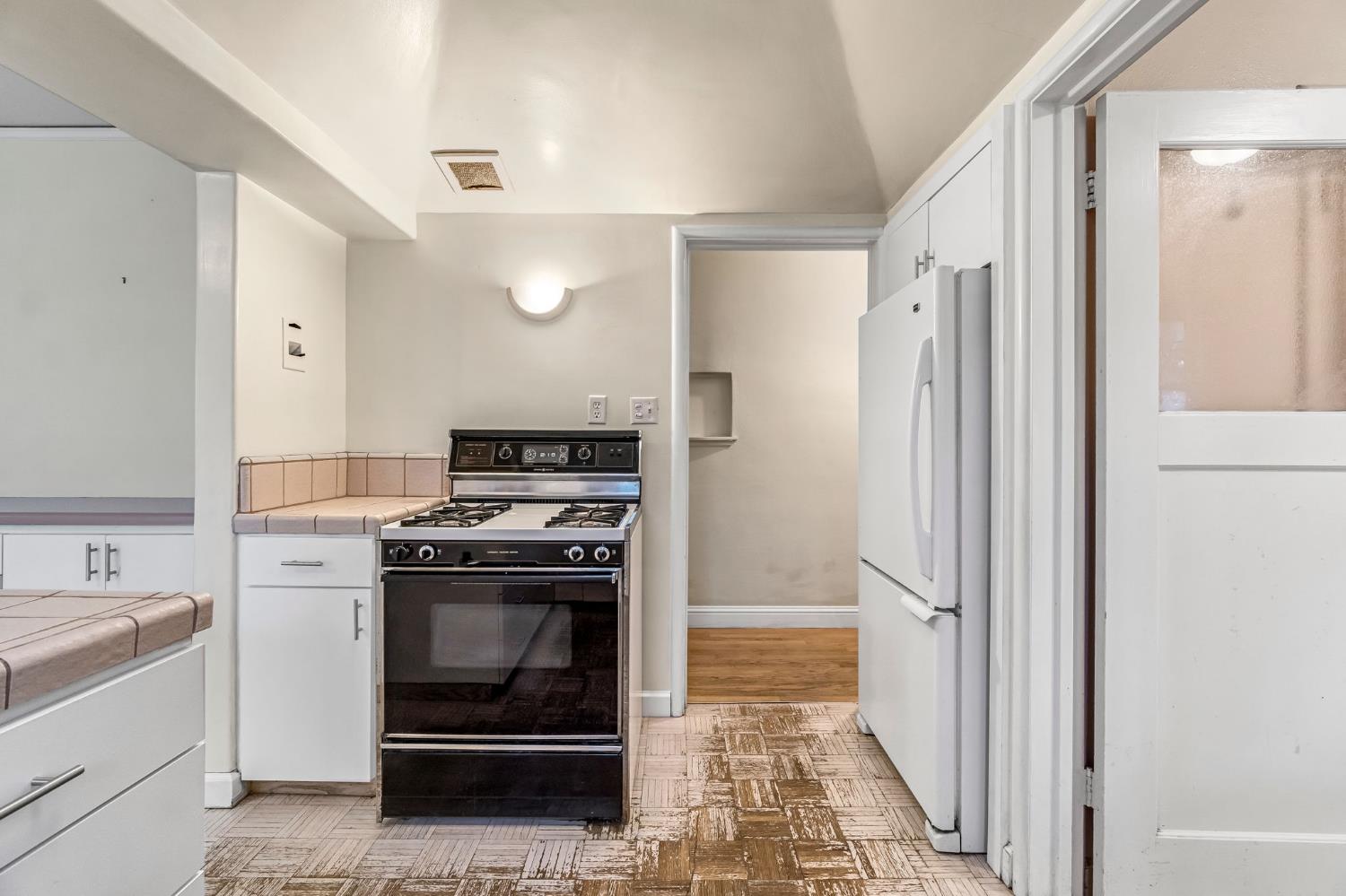 215 East Clinton Avenue Fresno, CA 93704 - Photo 12 of 29 a kitchen with a stove and a refrigerator
