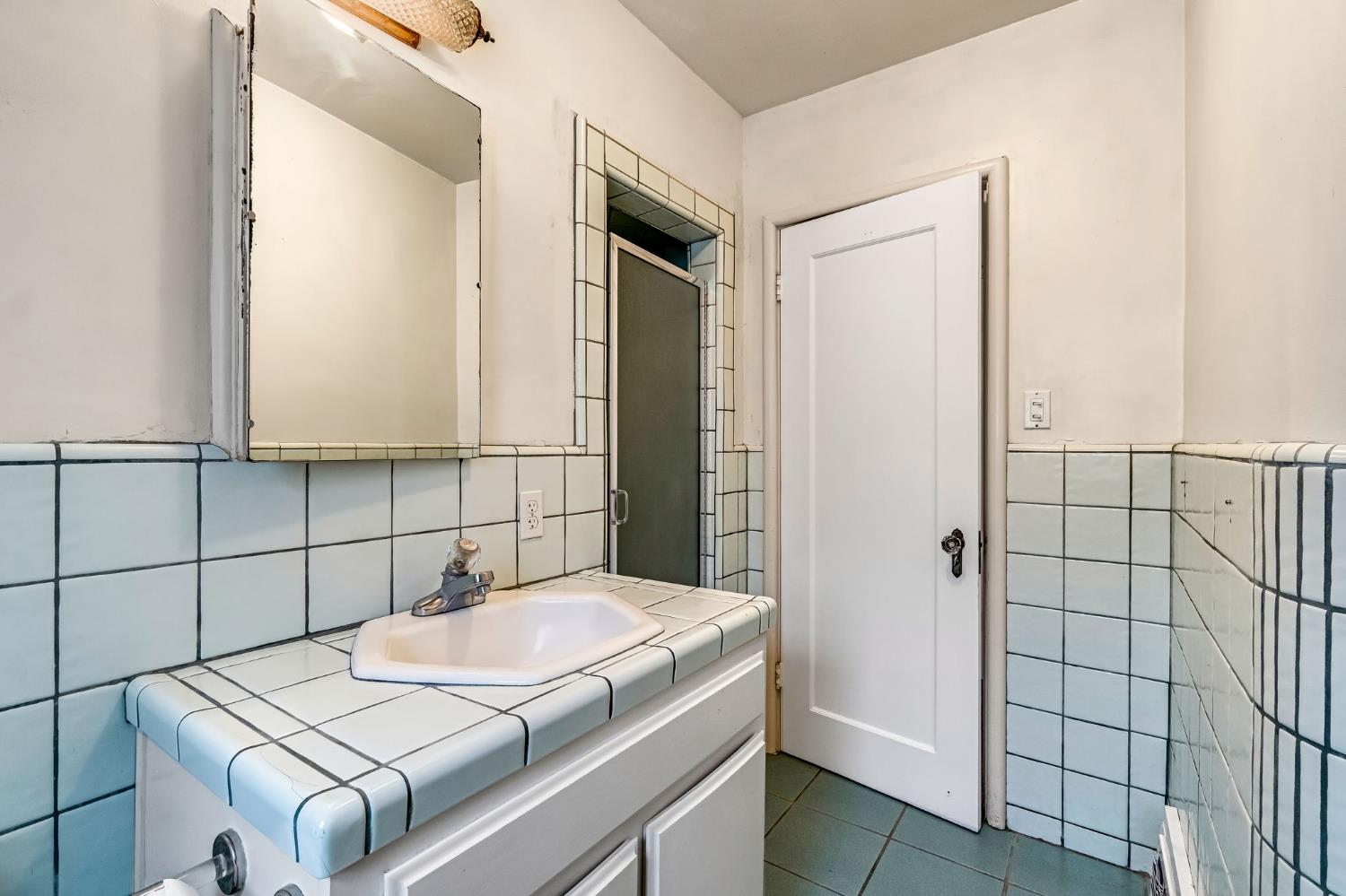 215 East Clinton Avenue Fresno, CA 93704 - Photo 17 of 29 a bathroom with a sink and mirror