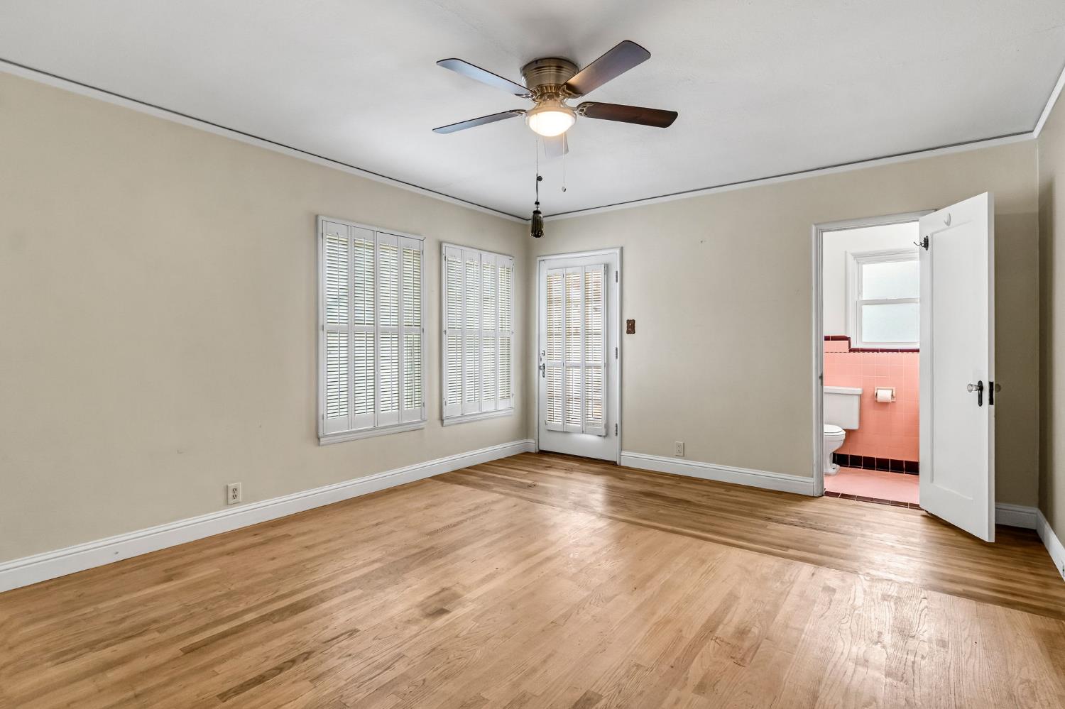 215 East Clinton Avenue Fresno, CA 93704 - Photo 20 of 29 a view of an empty room with a window and a ceiling fan