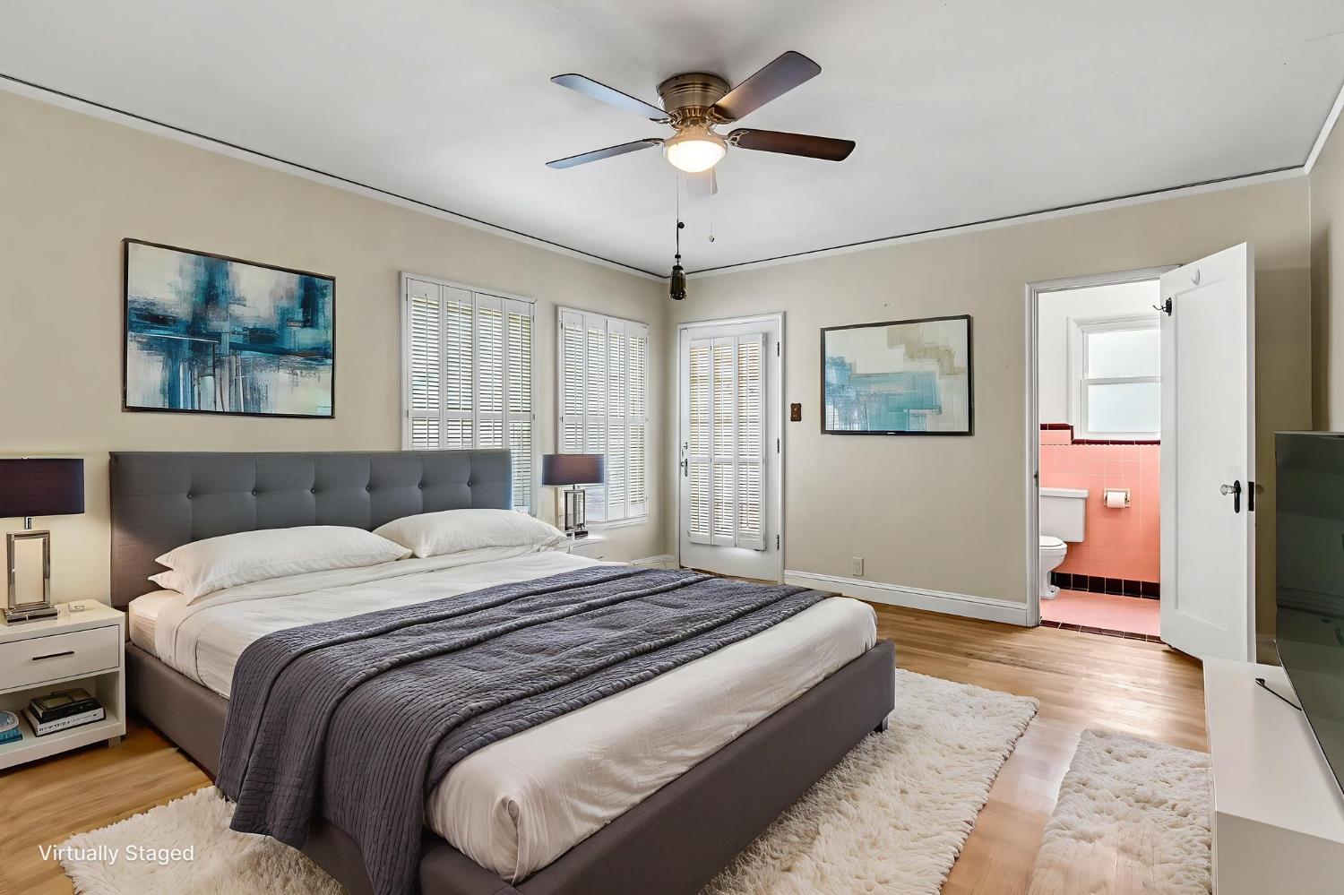 215 East Clinton Avenue Fresno, CA 93704 - Photo 21 of 29 a bedroom with a bed and a chandelier
