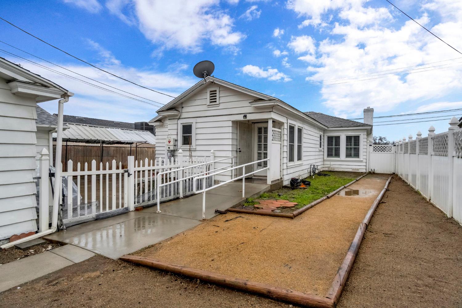 215 East Clinton Avenue Fresno, CA 93704 - Photo 27 of 29 a view of a house with wooden deck and a small yard