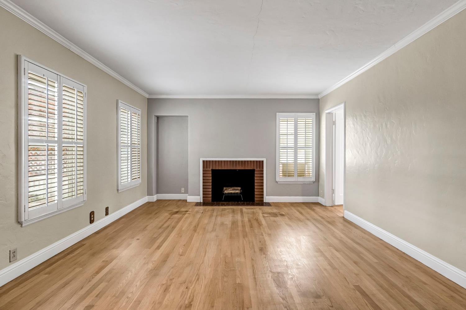 215 East Clinton Avenue Fresno, CA 93704 - Photo 4 of 29 a view of an empty room with a window and fireplace