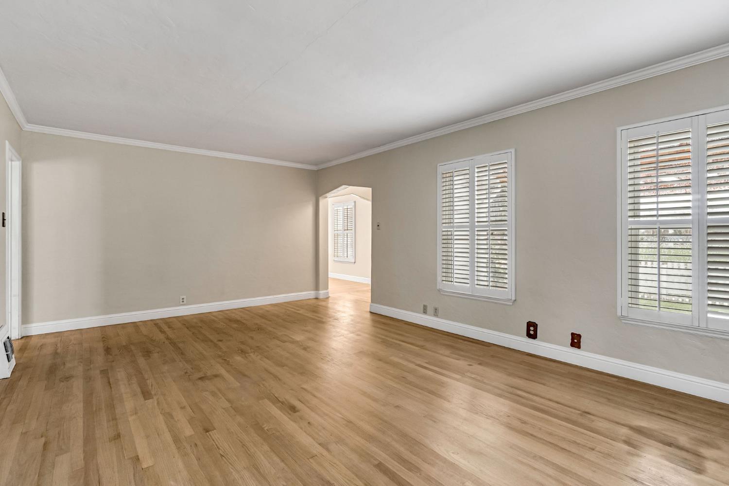 215 East Clinton Avenue Fresno, CA 93704 - Photo 7 of 29 a view of an empty room with wooden floor and a window