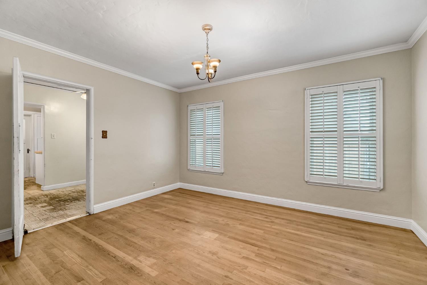 215 East Clinton Avenue Fresno, CA 93704 - Photo 8 of 29 a view of an empty room with wooden floor and a window