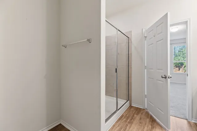 a en suite bathroom with a double vanity sink a large mirror and shower