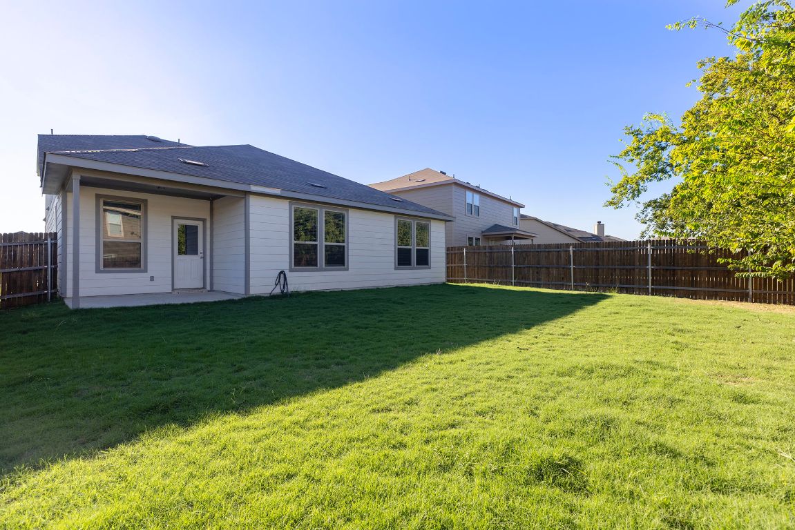 332 Spotted Rail Ridge Leander, TX 78641 - Photo 29 of 35 Back of property with a patio and a fenced backyard