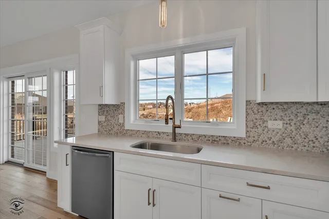 a kitchen with stainless steel appliances granite countertop a sink and a window