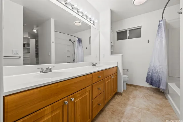 a bathroom with a toilet and a mirror