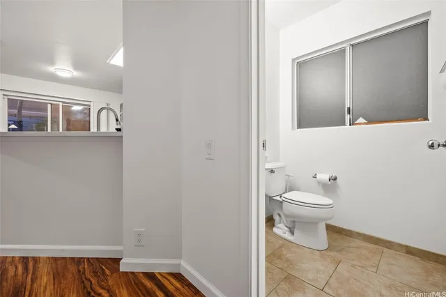 a bathroom with a sink toilet and mirror