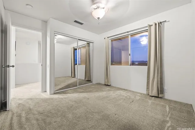 en empty room with fan and windows