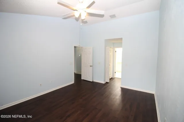 a view of an empty room with wooden floor
