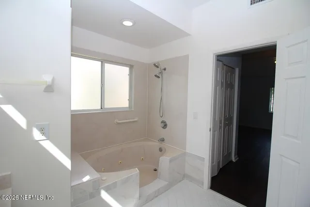a bathroom with a bathtub and a shower