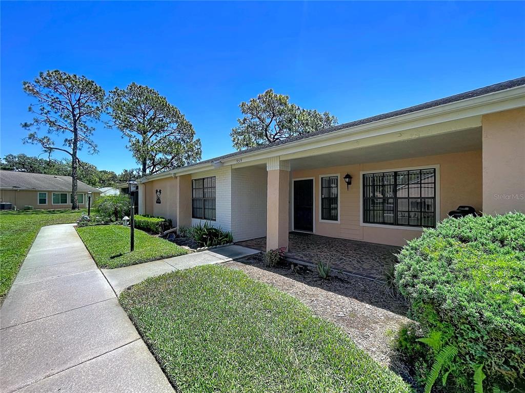 9319 Trowbridge Court New Port Richey, FL 34655 - Photo 64 of 78 front view of a house with a yard