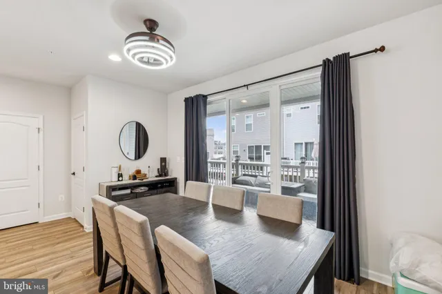 a view of a dining room and livingroom with furniture wooden floor a rug