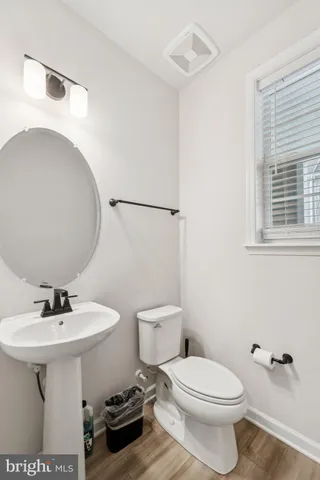 a bathroom with a sink toilet and a mirror