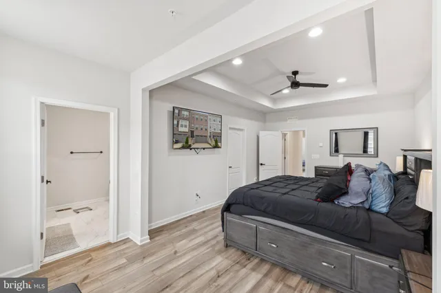 a living room with a bed and glass door