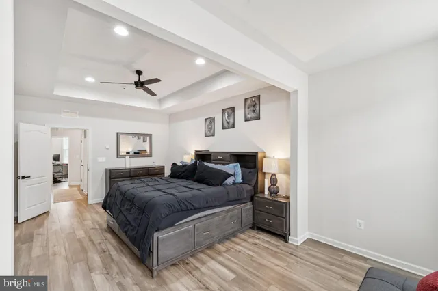 a bedroom with a large bed and a chandelier