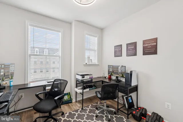 a livingroom with workspace and a window