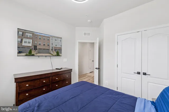 a bedroom with a bed and a closet with mirror