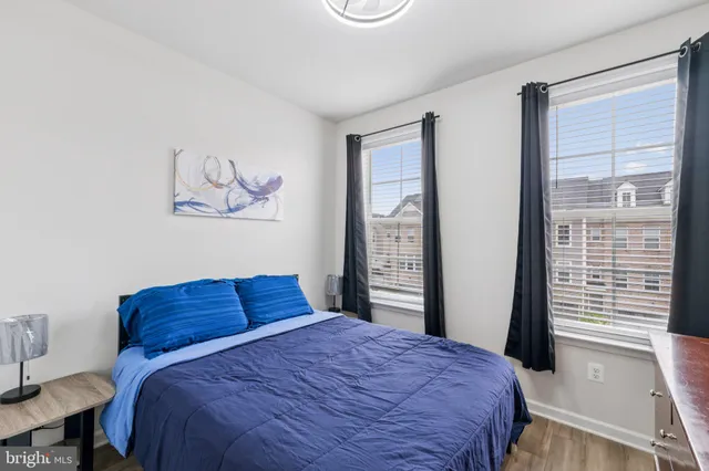 a bedroom with a bed and a large window