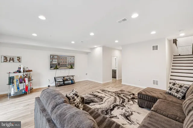 a living room with furniture and a rug