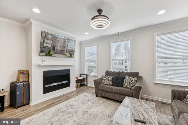 a living room with furniture a window and a fireplace