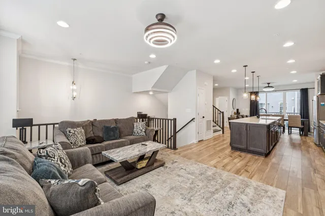 a living room with furniture and kitchen view