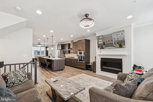 a living room with furniture kitchen and a fireplace