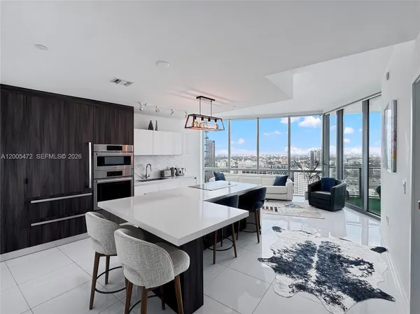 a kitchen with a table chairs and refrigerator