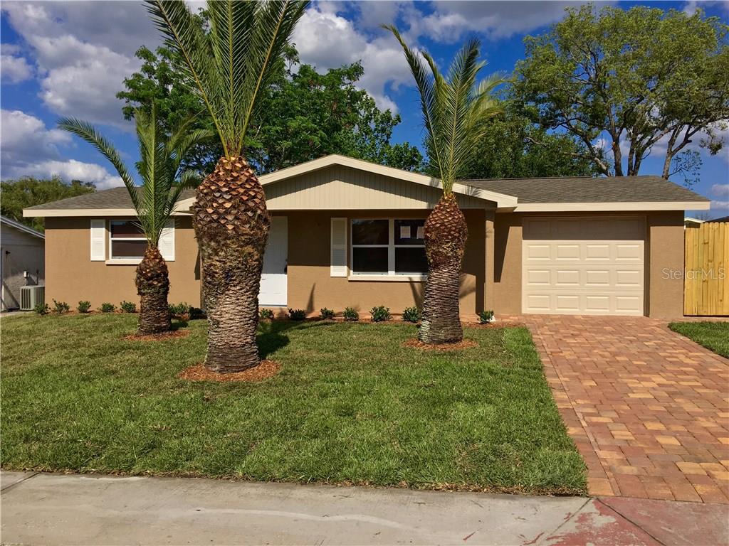 9026 Prosperity Lane Port Richey, FL 34668 - Photo 1 of 1 a front view of a house with a garden
