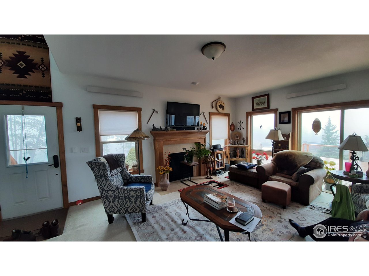2865 Davis Ranch Road Bellvue, CO 80512 - Photo 12 of 38 a living room with furniture and a fireplace