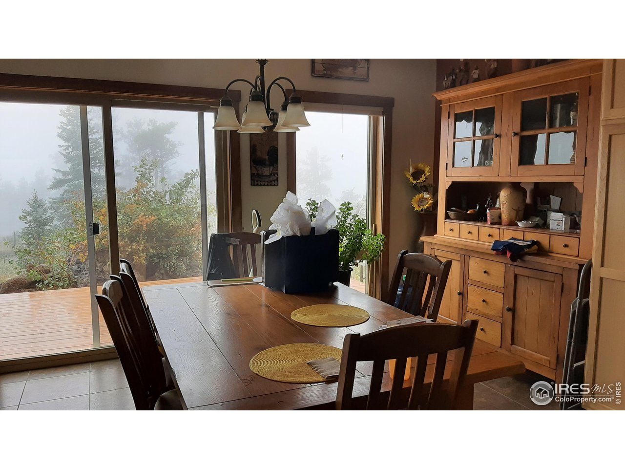 2865 Davis Ranch Road Bellvue, CO 80512 - Photo 14 of 38 a dining room with furniture and wooden floor