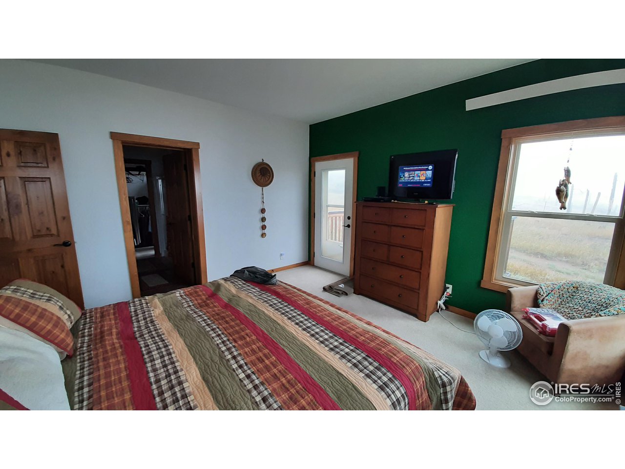 2865 Davis Ranch Road Bellvue, CO 80512 - Photo 17 of 38 a bedroom with a bed and a mirror