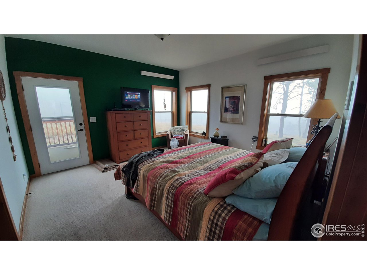 2865 Davis Ranch Road Bellvue, CO 80512 - Photo 19 of 38 a living room with a bed furniture and a flat tv screen