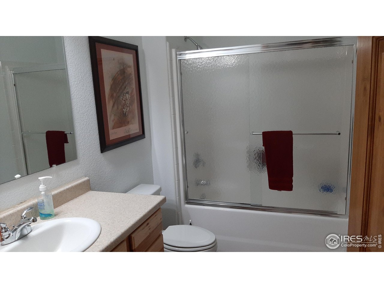 2865 Davis Ranch Road Bellvue, CO 80512 - Photo 24 of 38 a bathroom with a sink toilet and mirror