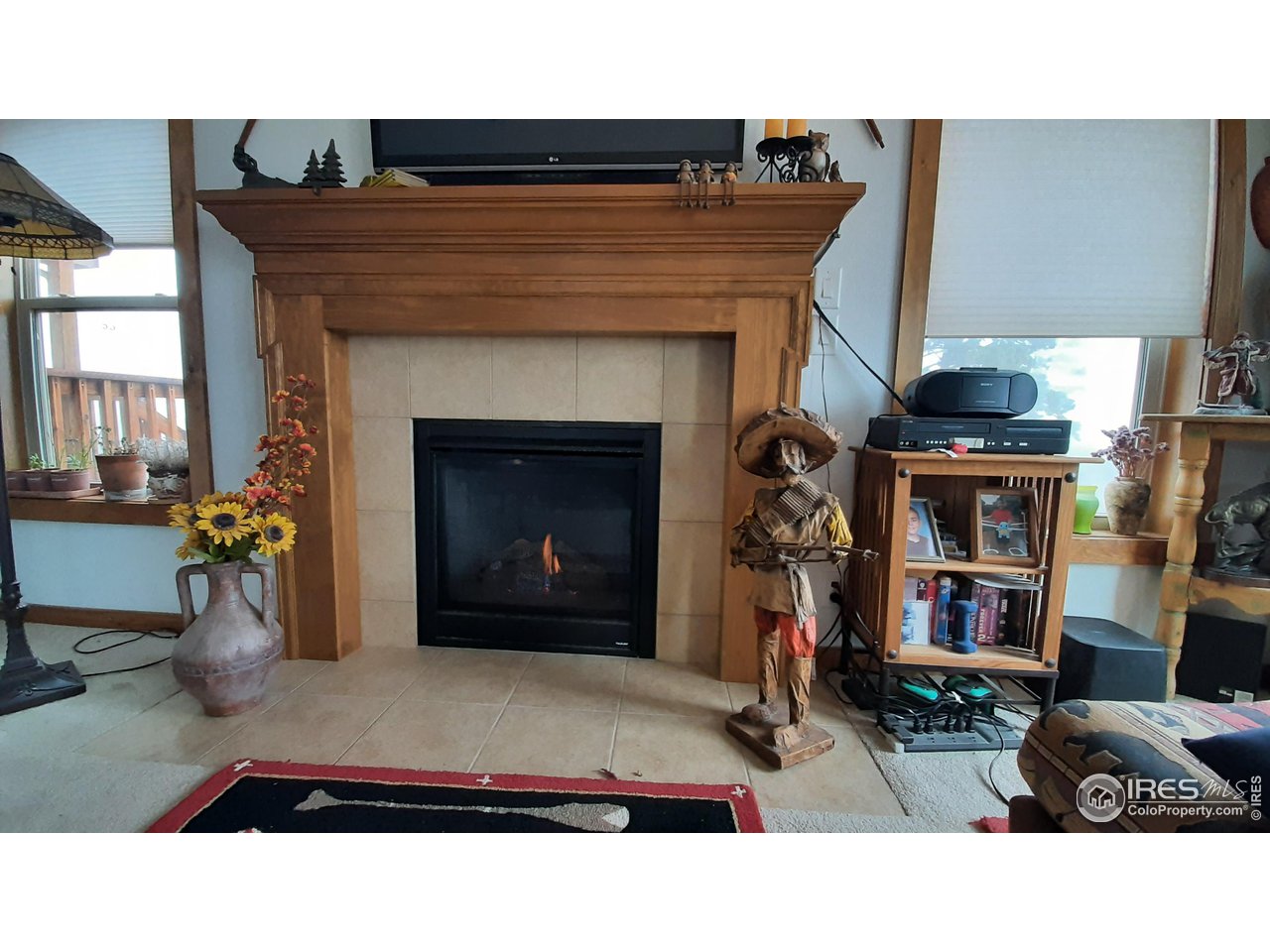 2865 Davis Ranch Road Bellvue, CO 80512 - Photo 25 of 38 a living room with furniture and a fireplace