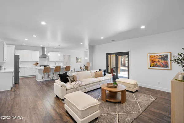 a living room with fireplace furniture and a wooden floor