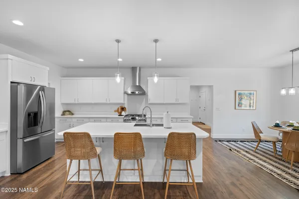 a kitchen with stainless steel appliances kitchen island granite countertop a sink and cabinets
