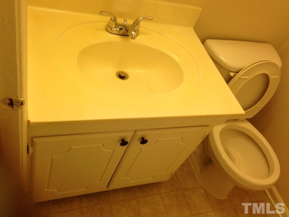 1108 Terrace Court Raleigh, NC 27615 - Photo 23 of 24 a bathroom with a sink and a mirror