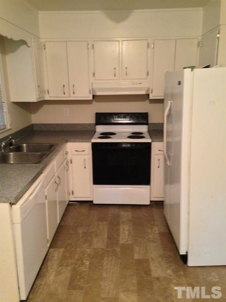 1108 Terrace Court Raleigh, NC 27615 - Photo 4 of 24 a kitchen with stainless steel appliances granite countertop a stove a refrigerator and white cabinets