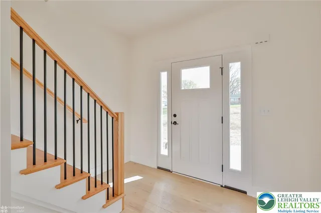 a view of an entryway with wooden floor
