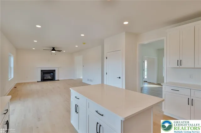 a kitchen with stainless steel appliances a refrigerator sink and white cabinets